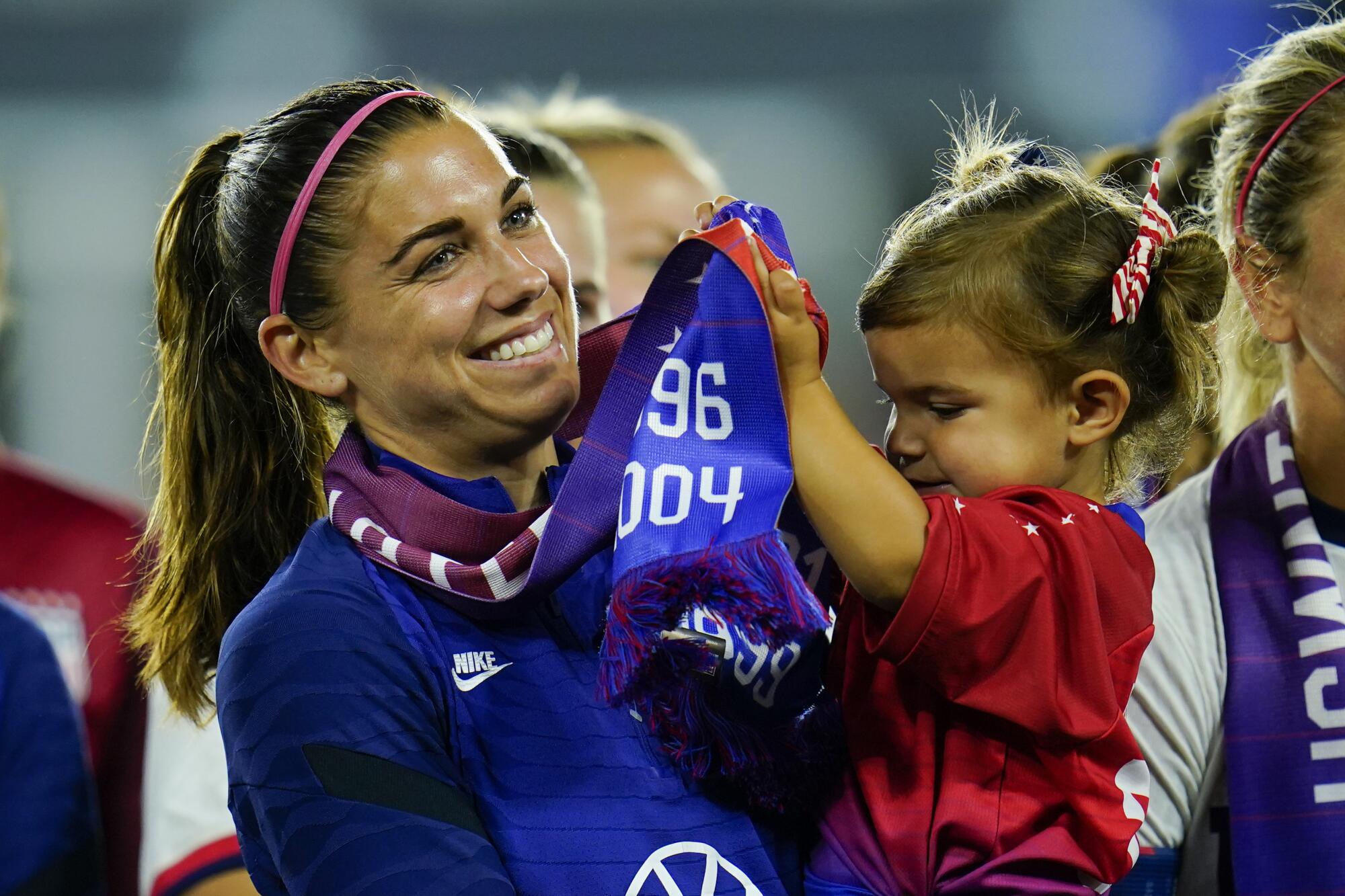 American star Alex Morgan holds her daughter, Charlie, during a U.S. Soccer event in Washington.