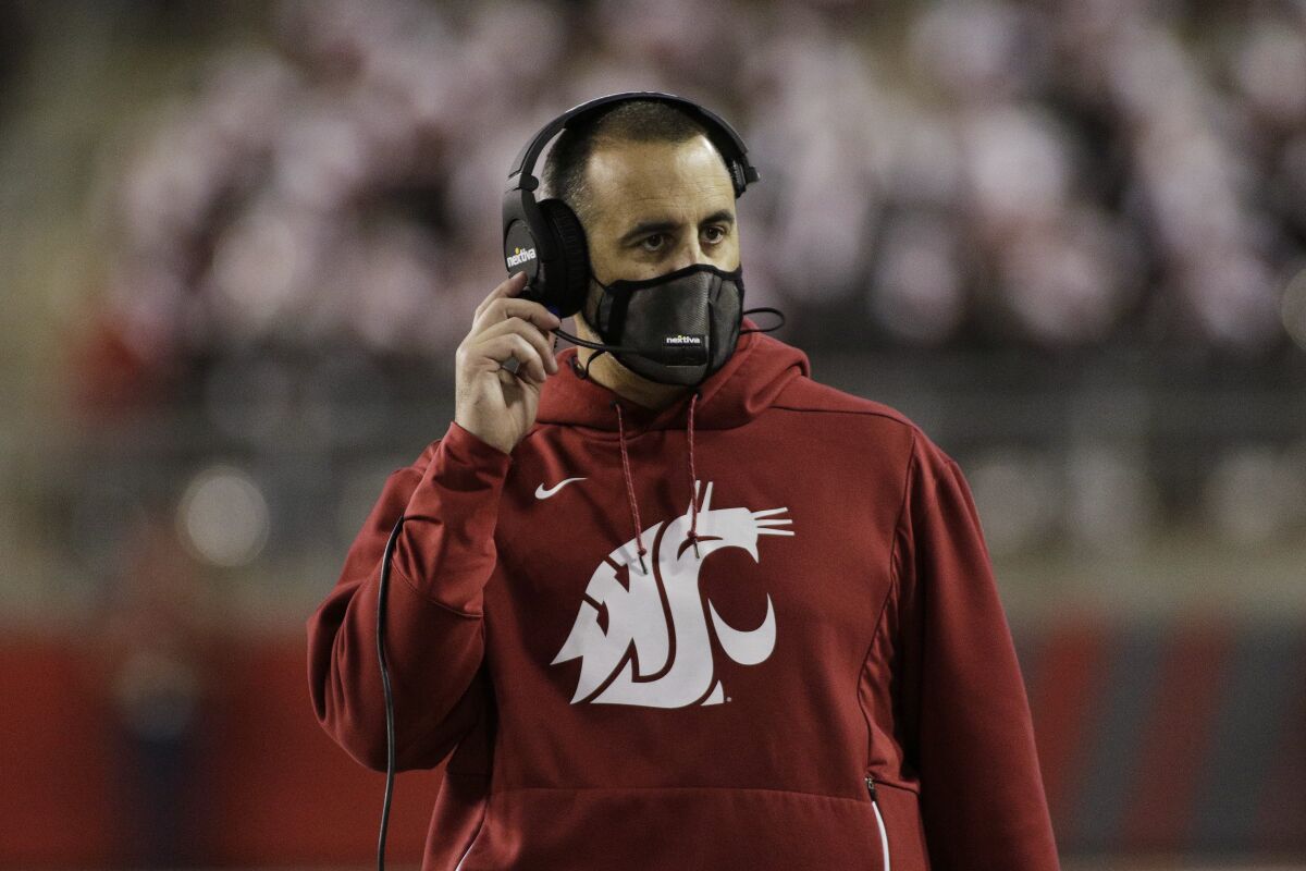 Washington State coach Nick Rolovich looks on.