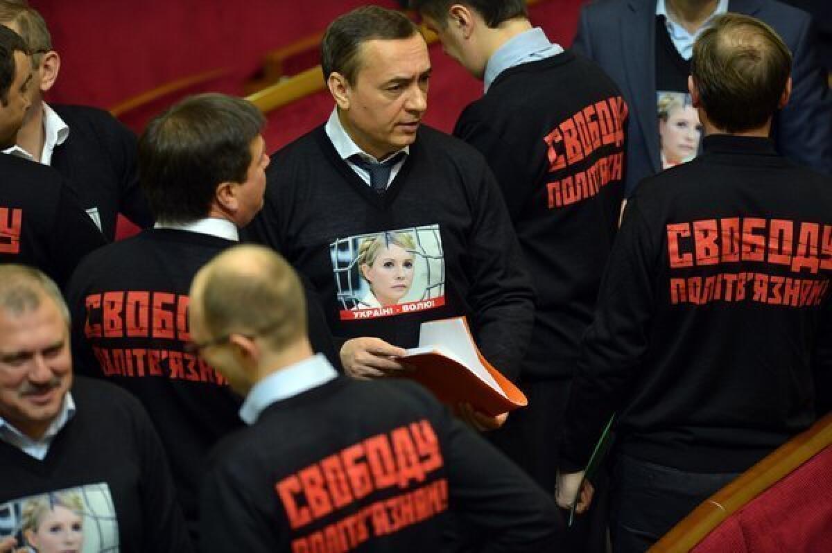 Ukrainian opposition deputies wear sweaters featuring a portrait of jailed former Prime Minister Yulia Tymoshenko during the opening ceremony of the newly elected parliament in Kiev. On the back, the sweaters say, "Free political prisoners!"