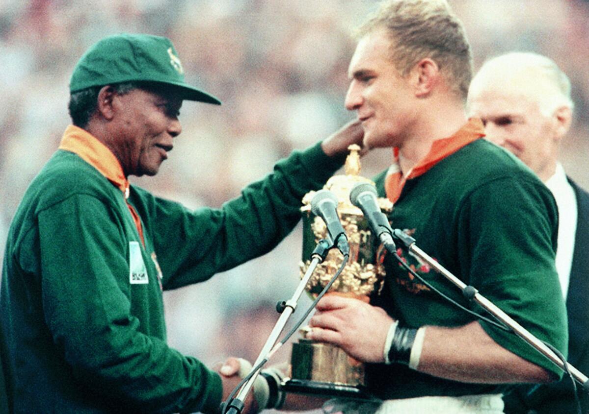 South African president Nelson Mandella shakes hands Springbok skipper Francois Pienaar following the rugby World Cup final in 1995.