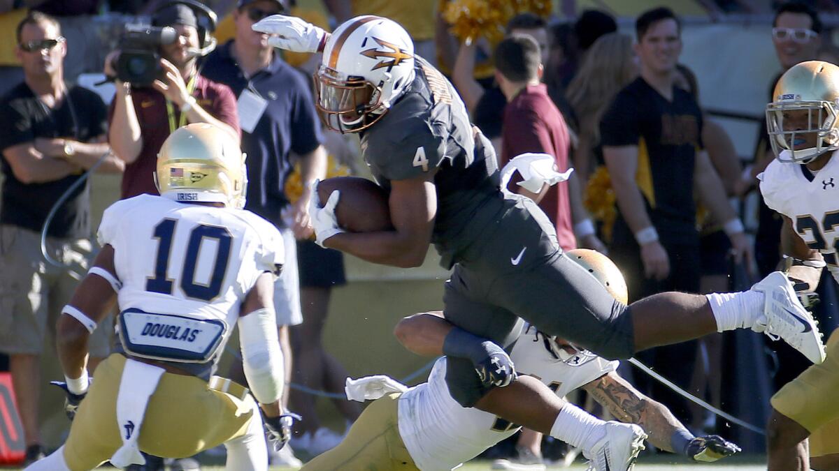Arizona State running back Demario Richard, center, is hit by Notre Dame cornerback Matthias Farley as Max Redfield, left, looks on during the first half of Saturday's game.
