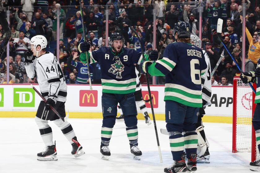 The Vancouver Canucks' Brock Boeser (6) celebrates his second-period goal with teammate J.T. Miller (9) on Nov. 18, 2022.