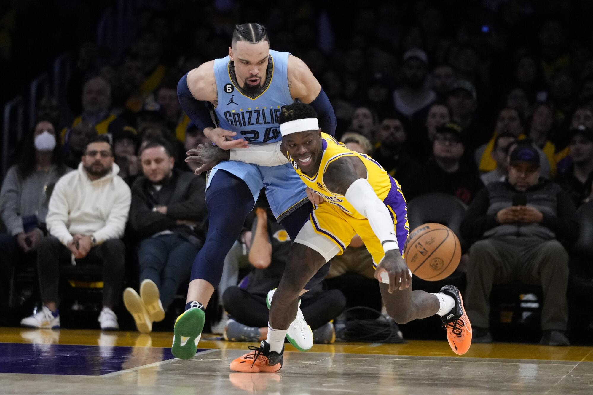 Dennis Schroder goes after a loose ball against Memphis Grizzlies' Dillon Brooks on March 7 at Crypto.com Arena.