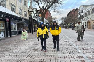 Two security guards walk down the Church Street Marketplace in Burlington, Vt., on Dec. 6, 2023. The city has strengthened security to help shoppers feel safe this holiday season amid concerns about drug activity, gun violence and retail theft. (AP Photo/Lisa Rathke)