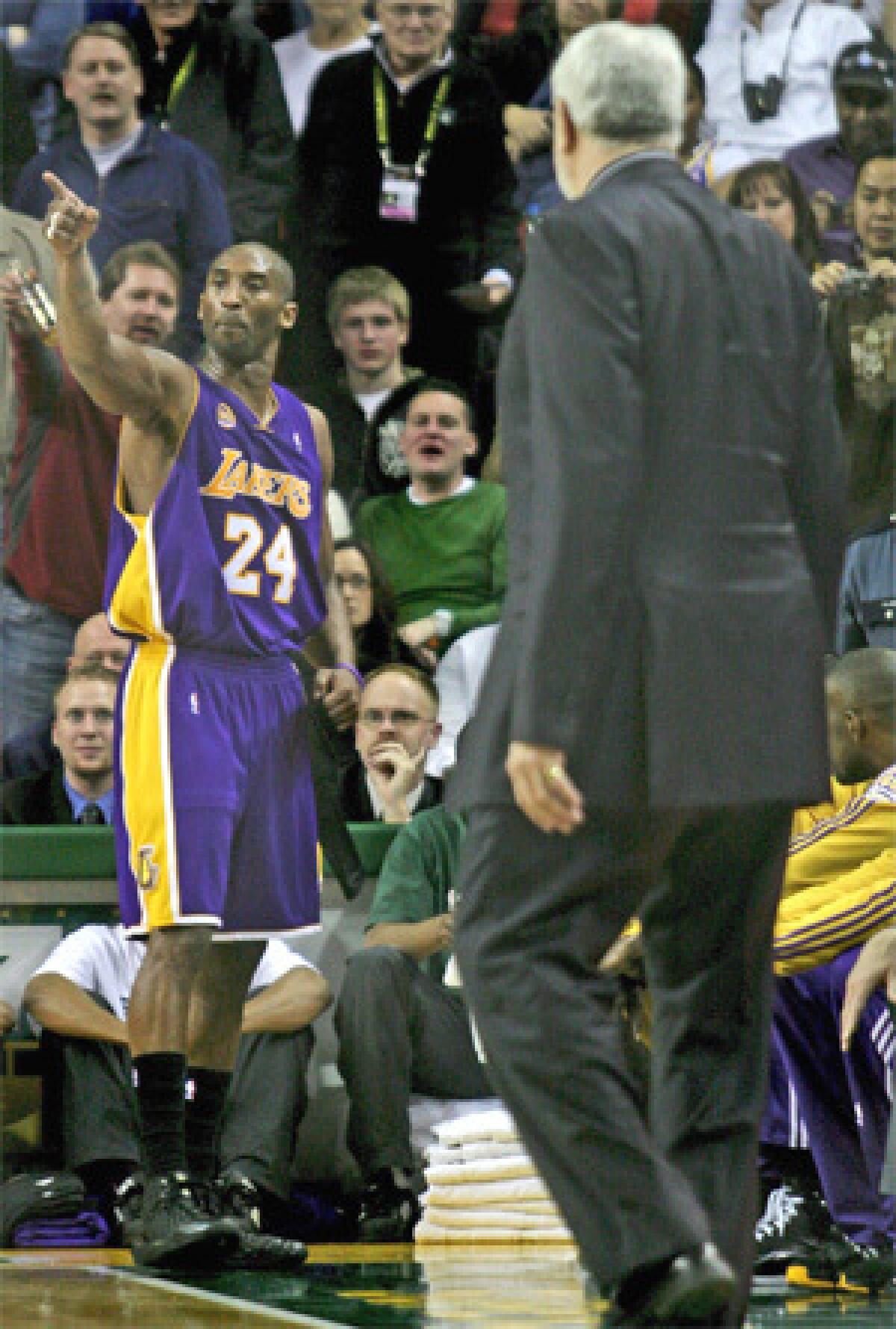 Kobe Bryant, left, yells at the referee after being ejected during third quarter of Sunday's game against the Seattle SuperSonics.