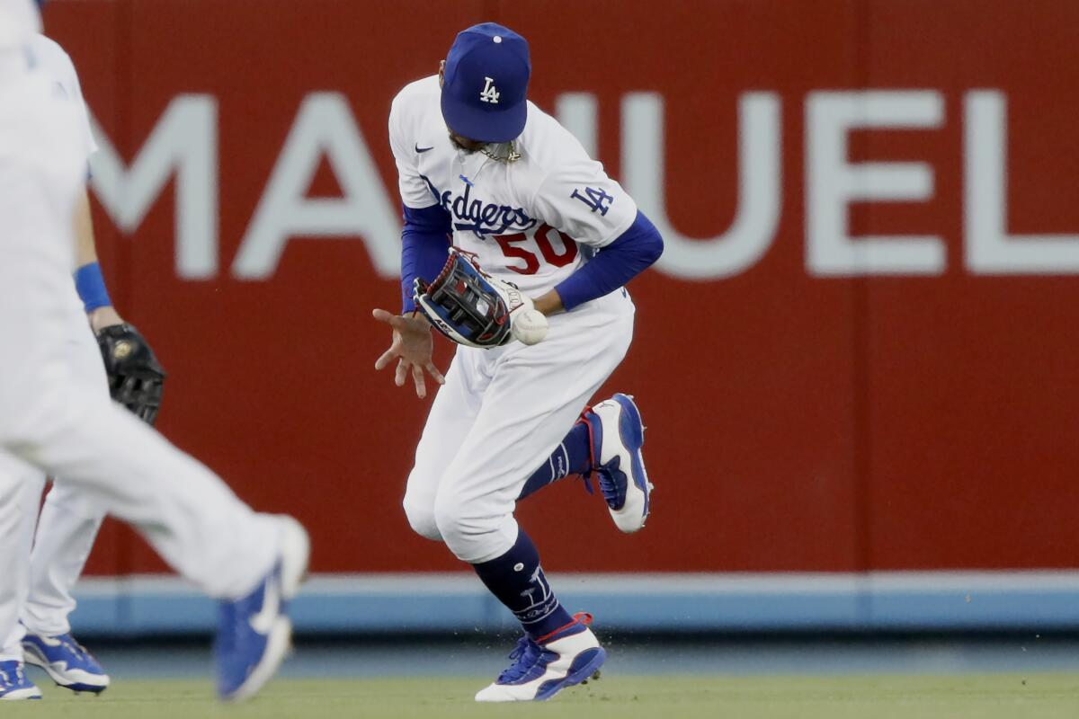 Dodgers center fielder Mookie Betts drops a fly ball hit by the Rangers' Isiah Kiner-Falefa.