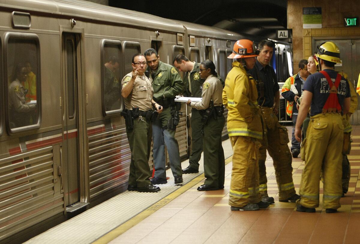 Los Angeles County sheriff's transit services bureau officers investigate the scene of a fatal accident involving a man killed by a Metro train on the Red Line at the Hollywood Boulevard and Vine Street station.