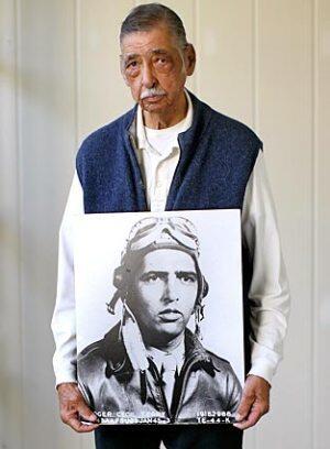 Roger Terry holds a picture of his younger self.