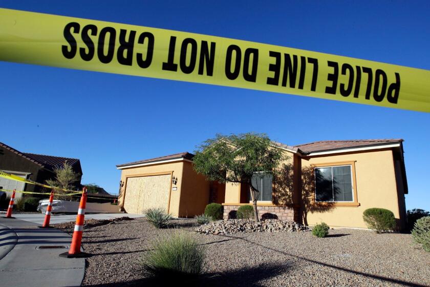 FILE - This Oct. 2, 2017 file photo shows police tape blocking off the home of Stephen Craig Paddock in Mesquite, Nev. A federal judge is being asked to unseal documents telling what federal agents learned before searching properties belonging to the gunman responsible for the Oct. 1, 2017 massacre on the Las Vegas Strip. Prosecutors aren't opposing a Friday, Jan. 12, 2018 request from media organizations for U.S. District Judge Jennifer Dorsey to release redacted affidavits underlying warrants for locations including Stephen Paddock's home in Mesquite. (AP Photo/Chris Carlson, File)