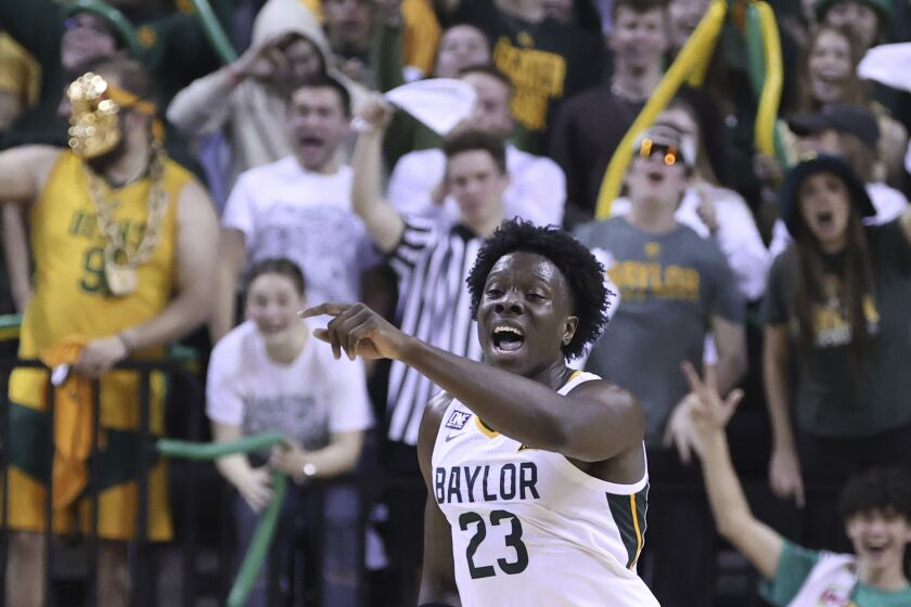 FILE - Baylor forward Jonathan Tchamwa Tchatchoua points up court after scoring a 3-point play against Texas Tech in the second half of an NCAA college basketball game, Saturday, Feb. 4, 2023, in Waco, Texas. Tchamwa Tchatchoua sees himself as a “walking miracle” after getting back on the court for 14th-ranked Baylor nearly a full year after a gruesome knee injury that many people thought would end his career.(AP Photo/Rod Aydelotte, File)