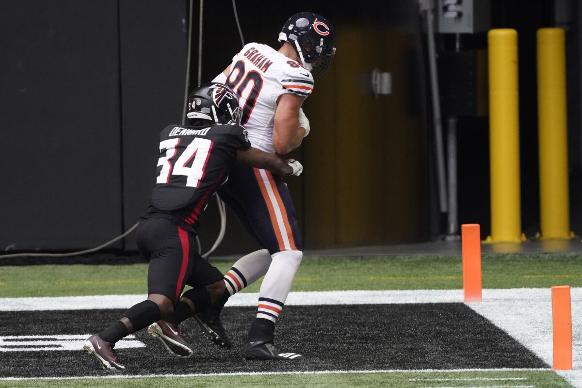 Chicago Bears tight end Jimmy Graham (80) scores a touchdown against Atlanta Falcons defensive back Darqueze Dennard (34) during the second half of an NFL football game, Sunday, Sept. 27, 2020, in Atlanta. (AP Photo/John Bazemore)