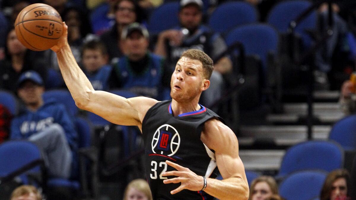 Clippers forward Blake Griffin tries to save a loose ball during the first half of a game against the Minnesota Timberwolves on Saturday.