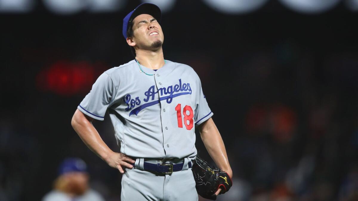Dodgers pitcher Kenta Maeda reacts after giving up a home run against San Francisco on Monday.
