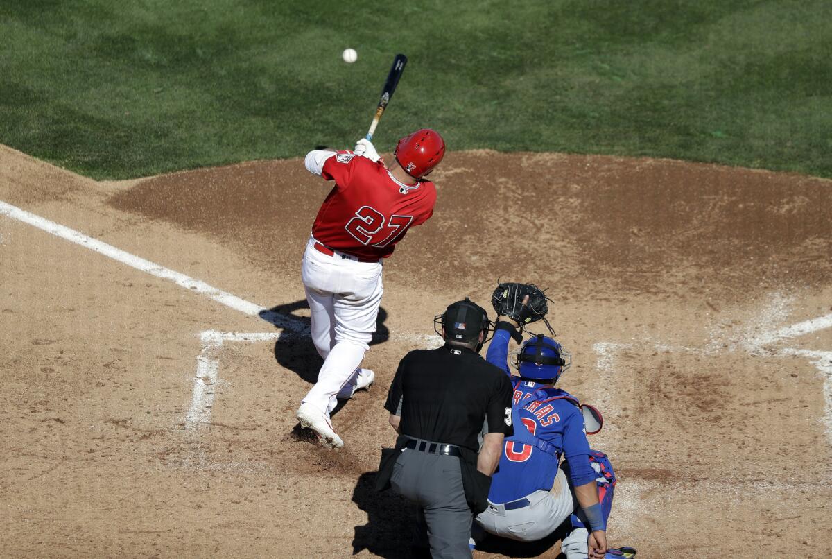 Mike Trout singles in front of Cubs catcher Willson Contreras during an exhibition game on March 5.