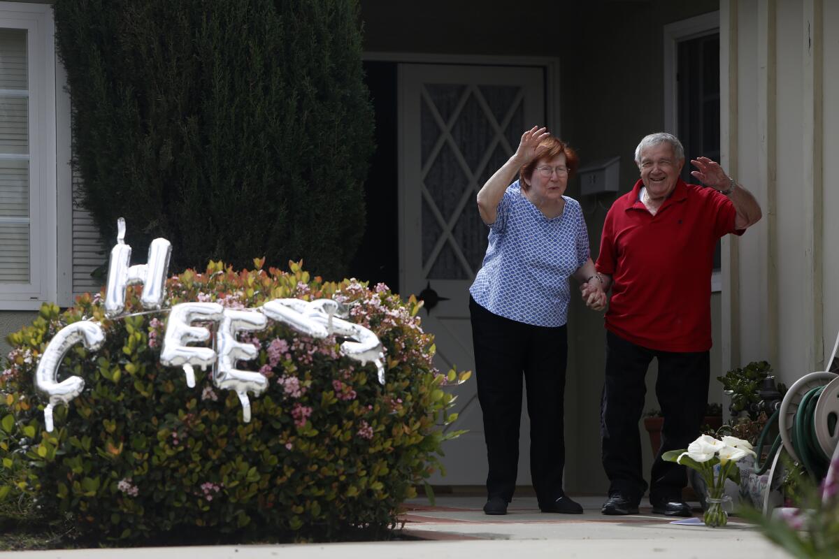 Libby and Harry Polakow greet neighbors who gathered Wednesday in Granada Hills to celebrate their 70th wedding anniversary.