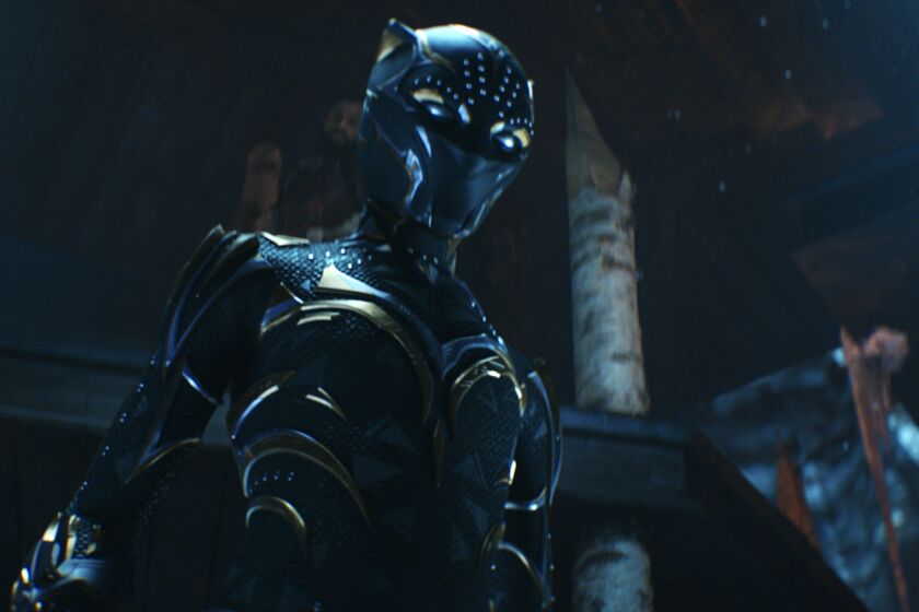 A person in a Black Panther suit looking downward