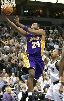Lakers guard Kobe Bryant goes to the basket over Minnesota Timberwolves guard Randy Foye during the second quarter.
