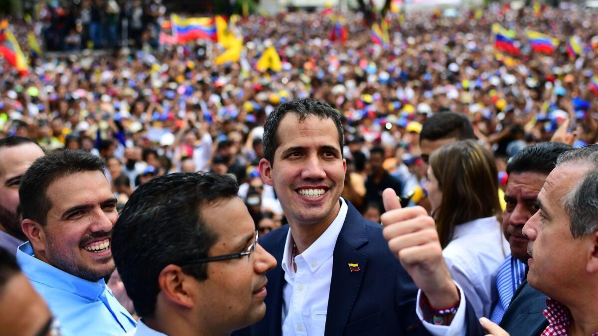Venezuelan opposition leader and self-proclaimed acting president Juan Guaido gives the thumbs up signal during a rally Monday after his return to Caracas.