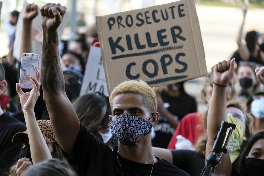 A demonstrator raises his fist during a protest in Minneapolis on Wednesday.