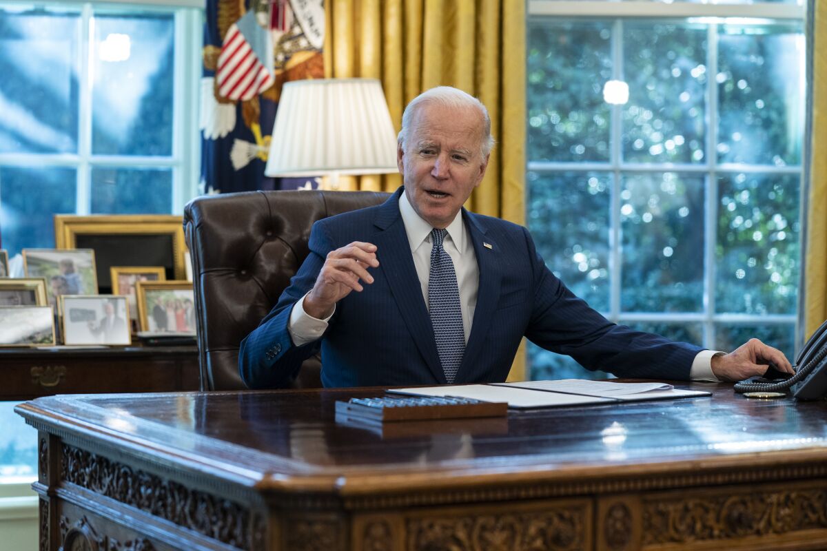 FILE - President Joe Biden speaks before signing an executive order to improve government services, in the Oval Office of the White House, Dec. 13, 2021, in Washington. Biden’s long arc in public life has always had one final ambition: to sit behind the Resolute Desk of the Oval Office. He achieved it, albeit at 78 the oldest person to assume the presidency. (AP Photo/Evan Vucci, File)