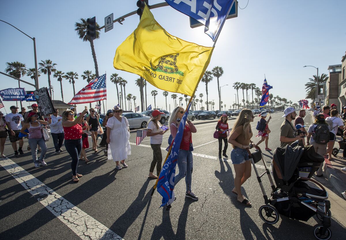 Trump supporters gather for an anti-mask "freedom march" in Huntington Beach on Monday, June 14.