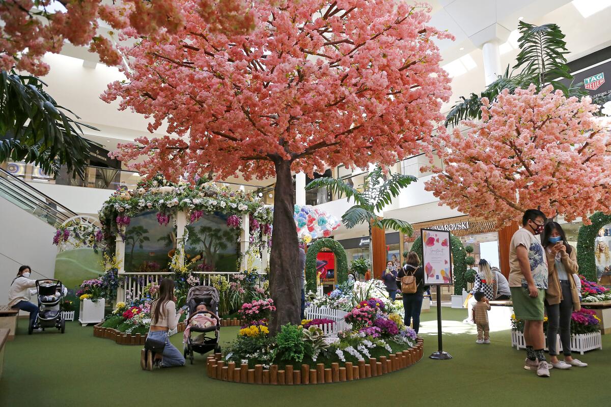Shoppers on Friday take in the "Springtime Gardens" art exhibit at South Coast Plaza, open now through April 15.