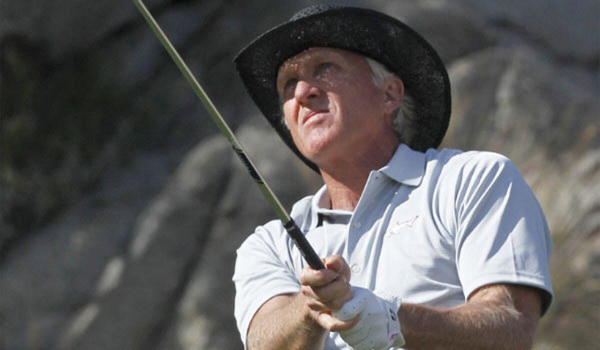 Greg Norman watches his tee shot on the 17th hole during a practice round on the Arnold Palmer Private course at PGA West for the 2012 Humana Challenge golf tournament in La Quinta.