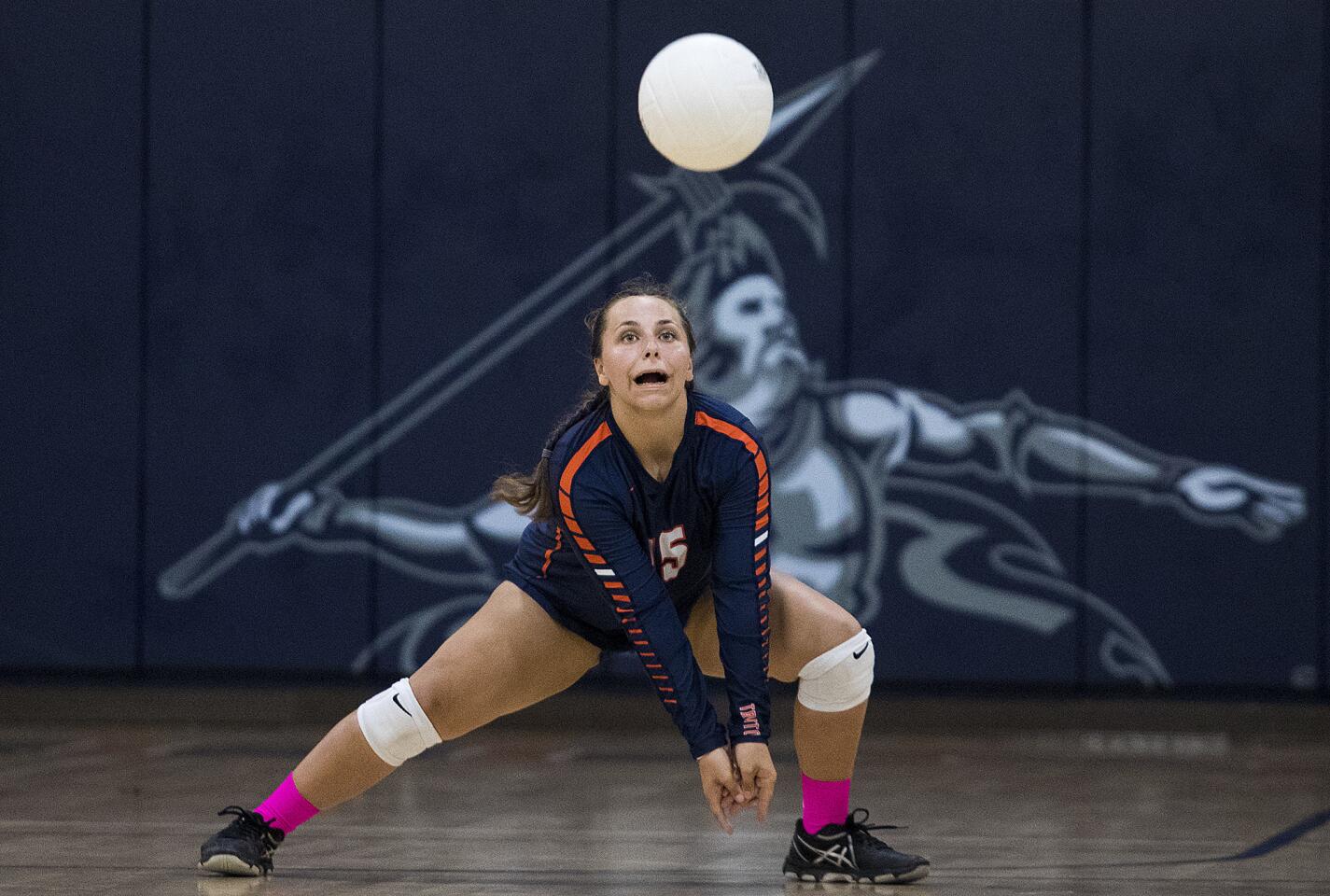 Pacifica Christian's Anna Eddy digs a ball during a game against Orangewood Academy on Thursday, October 19.