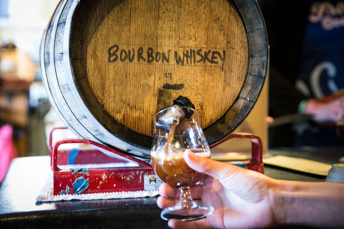A beer aged in a bourbon whiskey barrel being poured at the long-standing Karl Strauss Tasting Room, located in Pacific Beach.