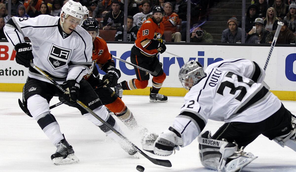 Los Angeles Kings defenseman Brayden McNabb (3) sweeps the puck away from Los Angeles Kings goalie Jonathan Quick (32) as Anaheim Ducks center Ryan Kesler (17) looks on during the second period Sunday night.