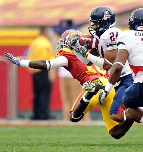 Arizona's Trevin Wade intercepts a pass intended for USC's Damian Williams in the first quarter Saturday.