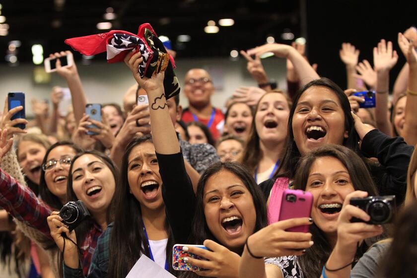 Fans cheer as their favorite YouTube stars from Our2ndLife arrive for their photo and autograph session during the three-day VidCon convention at the Anaheim Convention Center on Friday, June 27, 2014.
