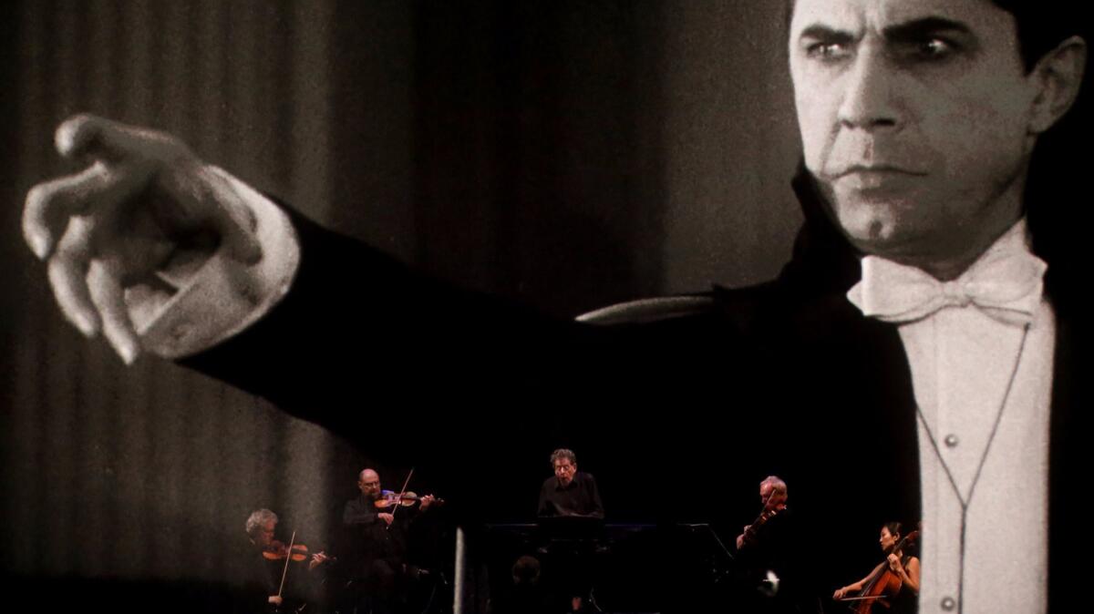 Philip Glass, center, and the Kronos Quartet performing as "Dracula" screened at the Theatre at the Ace Hotel in 2015. They are reviving the performance this Halloween weekend at Orange County's Segerstrom Center for the Arts.