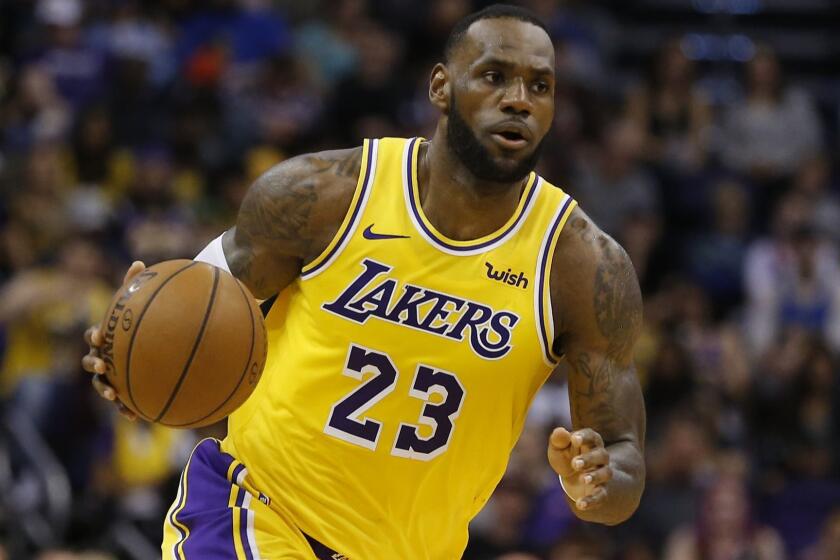 FILE - In this Saturday, March 2, 2019 file photo, Los Angeles Lakers forward LeBron James (23) controls the ball in the second half during an NBA basketball game against the Phoenix Suns in Phoenix. Though LeBron James didn't make the playoffs in his first season in Los Angeles, his move to the Lakers paid off in jersey sales. The NBA announced Thursday, April 25, 2019 that James had the most popular individual jersey during the regular season and that the Lakers sold the most team merchandise. They knocked off Stephen Curry and the Golden State Warriors, who had been the most popular player and team for three consecutive seasons. (AP Photo/Rick Scuteri, File)