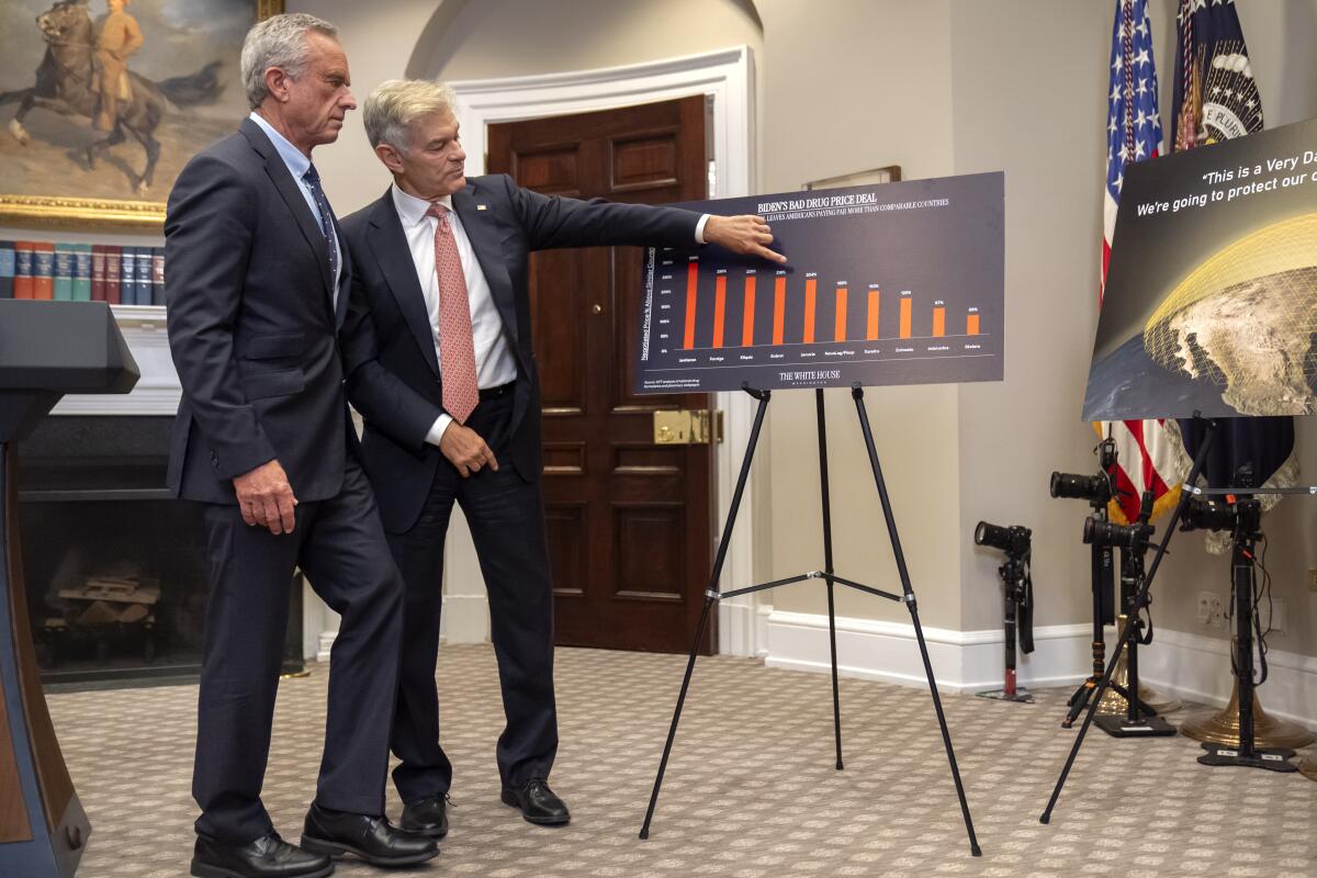 Robert F. Kennedy Jr., left, and Dr. Mehmet Oz look at a chart