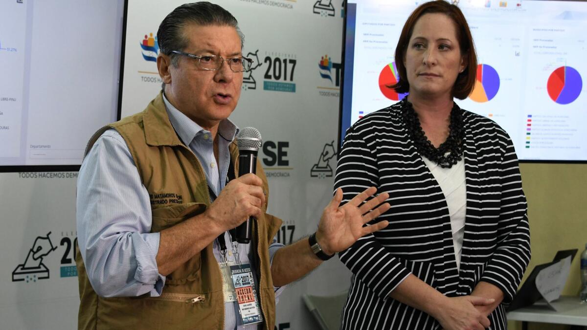 Heide Fulton, U.S. charge d'affaires in Honduras, and David Matamoros, president of Honduras' Supreme Electoral Tribunal, speak Dec. 9 at a news conference in Tegucigalpa..
