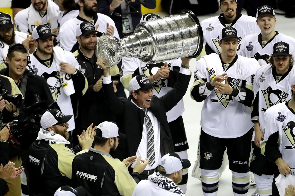 Penguins Coach Mike Sullivan celebrates with the Stanley Cup after their 3-1 victory over the San Jose Sharks in Game 6.