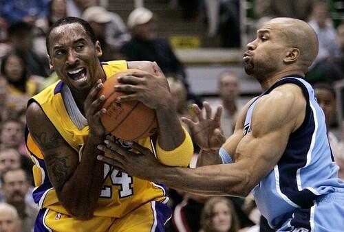 Utah Jazz guard Derek Fisher fouls Los Angeles Lakers guard Kobe Bryant during the first quarter.