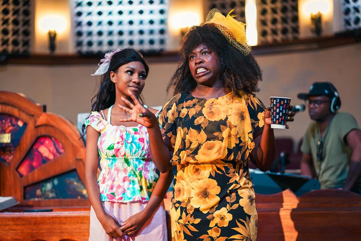 Two women in colorful clothes chatting in church. 