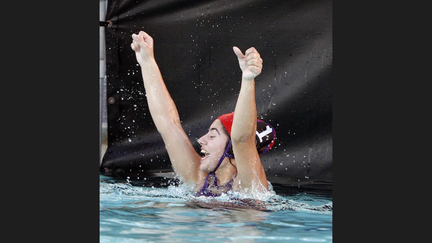 Hoover's goalie Lusin Yengibaryan celebrates the win over Burbank when the buzzer to end the game sounds in a Pacific League girls' water polo match at Hoover High School on Thursday, January 11, 2018. Hoover won the match by one point, 10-9.