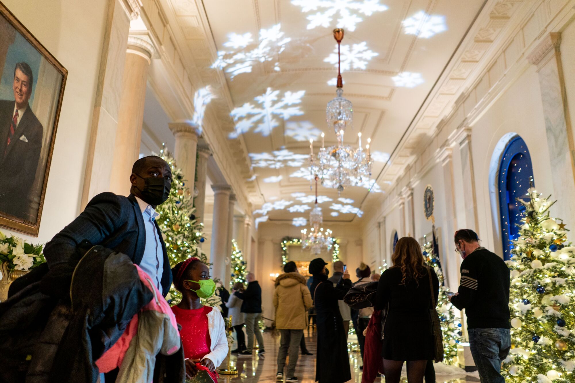 Members of the public stand in Cross Hall during a Christmastime tour.