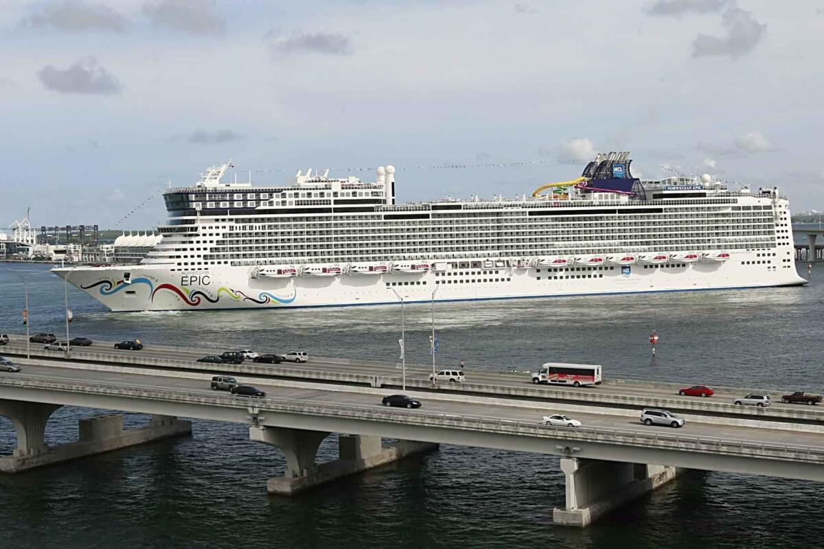 FILE - In this July 7, 2010, file photo, the Norwegian Epic, owned by the Norwegian Cruise Line Corporation, sails through the Government Cut to the Port of Miami in Miami. Norwegian Cruise Line is challenging a new Florida law that prevents cruise companies from requiring passengers to show proof of vaccination against the COVID-19 virus. The lawsuit, filed Tuesday, July 13, 2021, in Miami federal court, contends that the law jeopardizes safe operation of cruise ships by increasing risk of contracting the virus. Norwegian intends to restart cruises from Florida ports Aug. 15 with vaccinations required for all passengers. (Pedro Portal/El Nuevo Herald via AP, File)