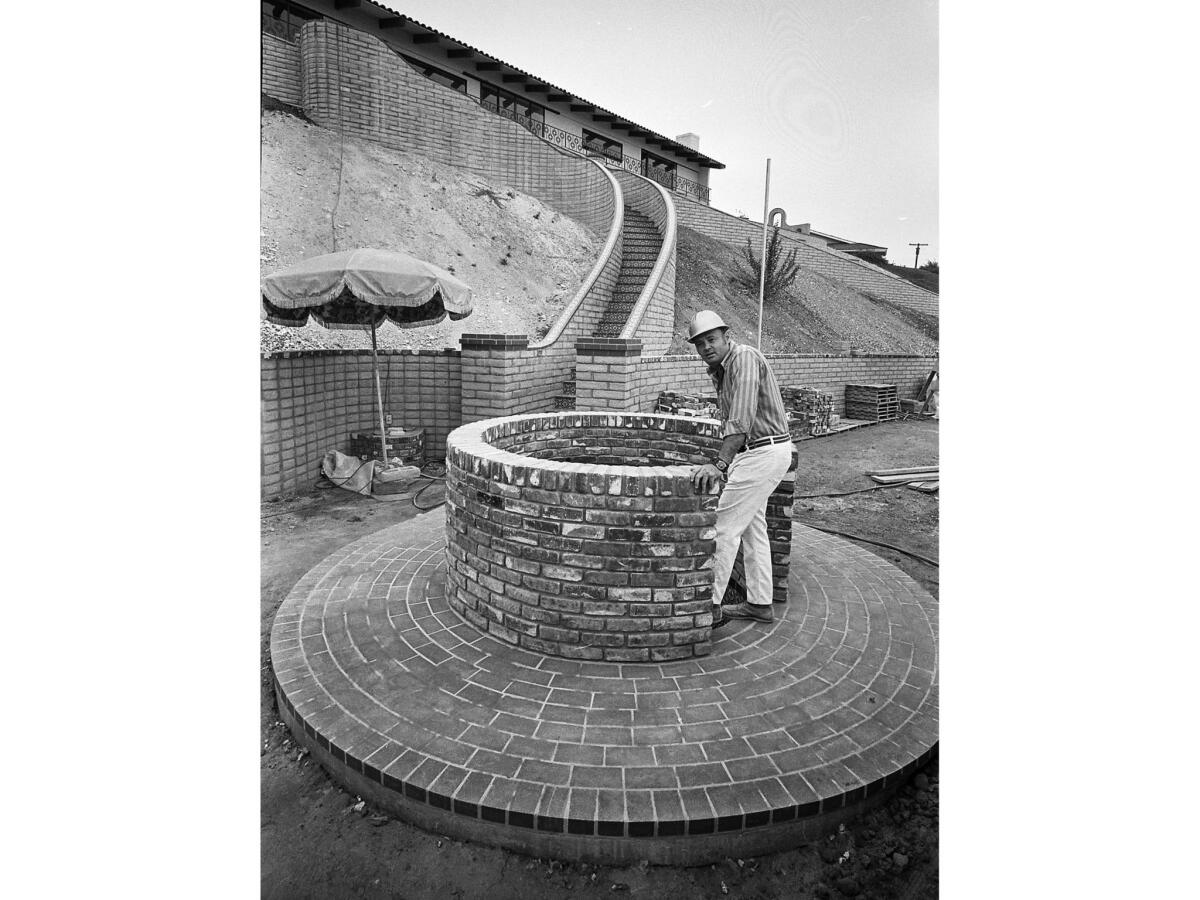 June, 1971: Bill Bounds at the entrance of spiral staircase leading to his smog escape chamber at his Palos Verdes Peninsula home.