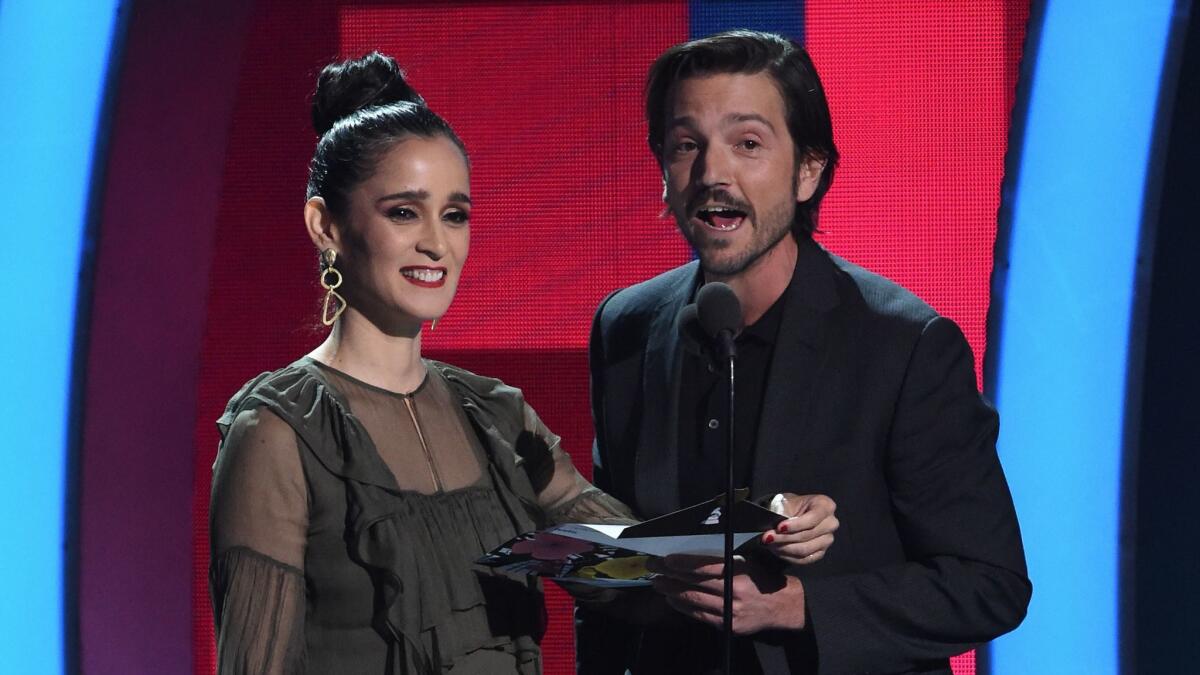Julieta Venegas, left, with Diego Luna, who called on Latinos to fight discrimination.