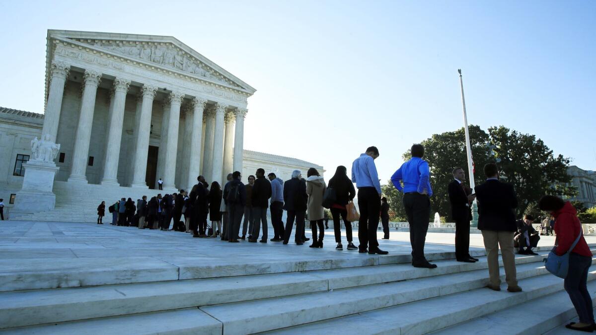 People line up outside the U.S. Supreme Court in Washington.