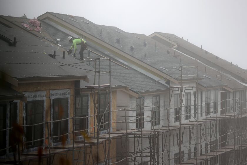 SOUTH SAN FRANCISCO, CALIFORNIA - SEPTEMBER 24: A worker stands on the roof of a new home under construction on September 24, 2020 in South San Francisco, California. Sales of new single-family homes rose 4.8 percent in August and surpassed an annual rate of 1 million for the first time in 14 years. (Photo by Justin Sullivan/Getty Images)