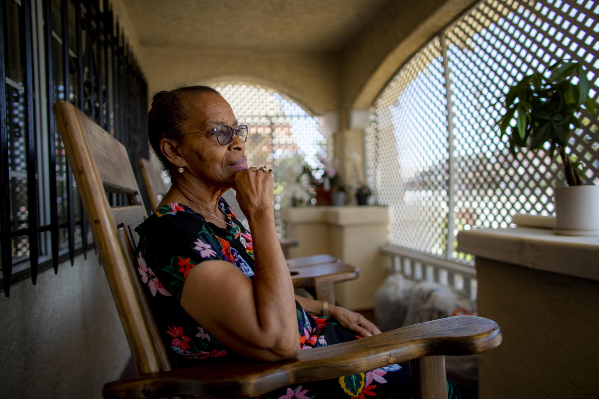 Mildred Davis sits on the front porch of her home which she shared with her husband Willie Davis 