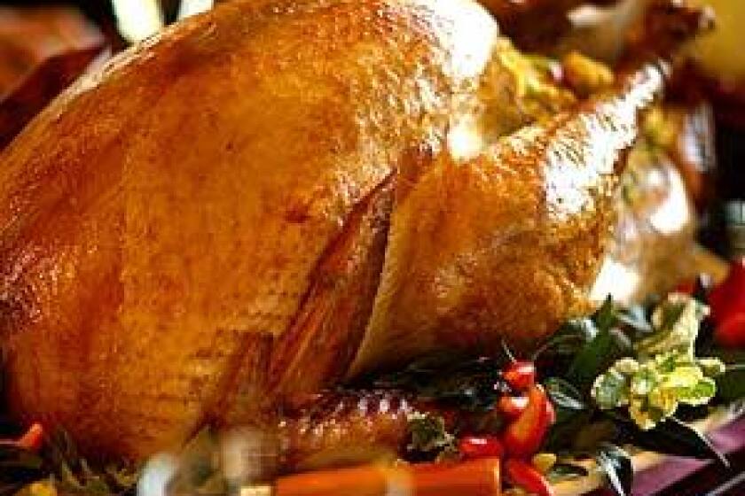A MEAL TO LINGER OVER: Soy-brined turkey is the centerpiece of a Thanksgiving dinner, served with sausage-cornbread stuffing.