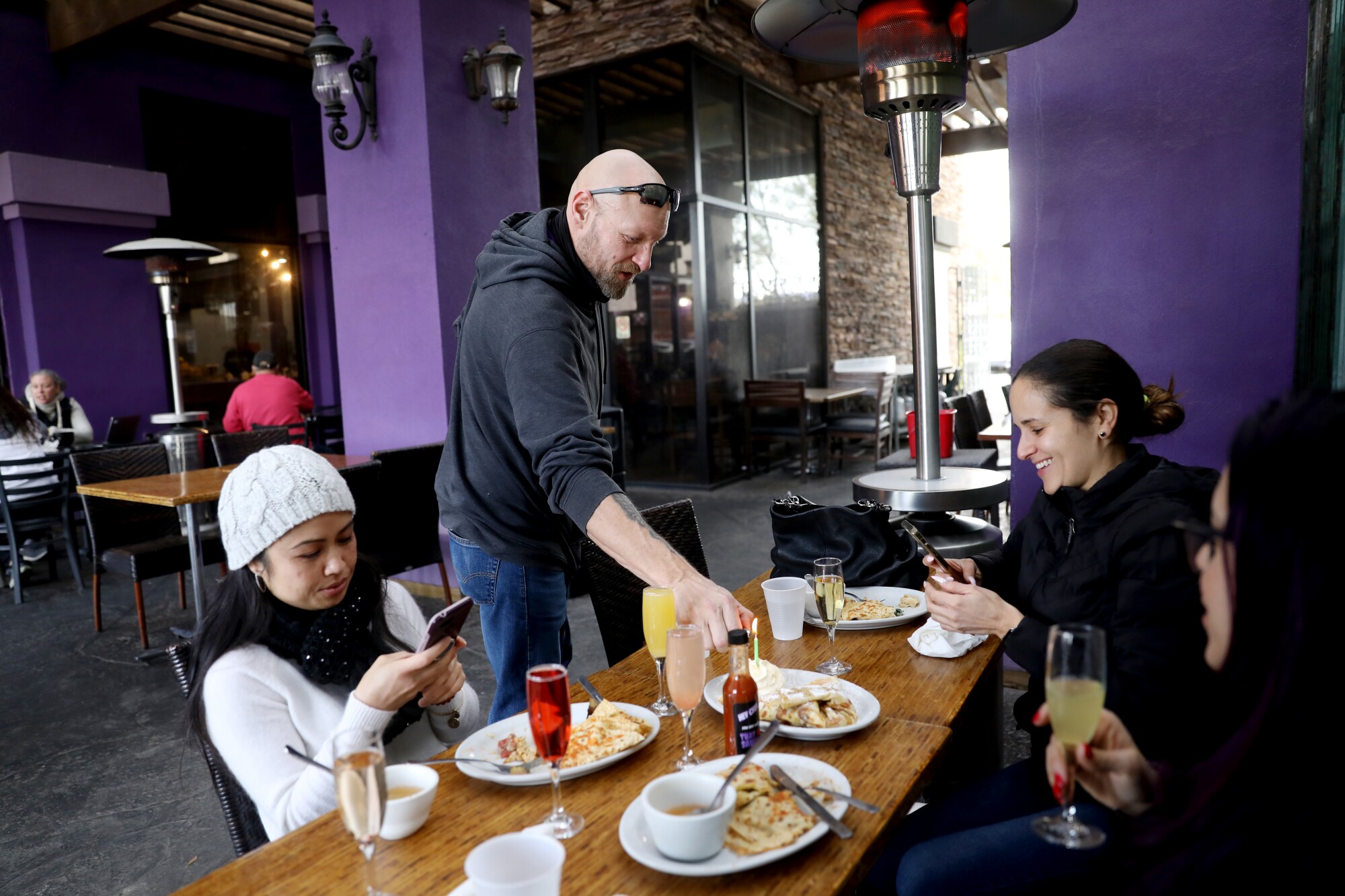 Lou Remillard atiende a los clientes en su restaurante.