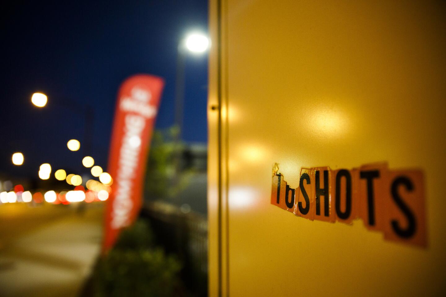 The phrase "16 shots" is attached to the side of a sign in the 4100 block of South Pulaski Road on Sept. 13, 2018, near the location where Laquan McDonald was shot by Chicago officer Jason Van Dyke in 2014. (Armando L. Sanchez/Chicago Tribune)